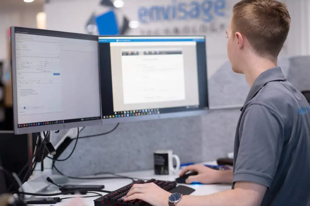 Envisage Technology team member working on his computer