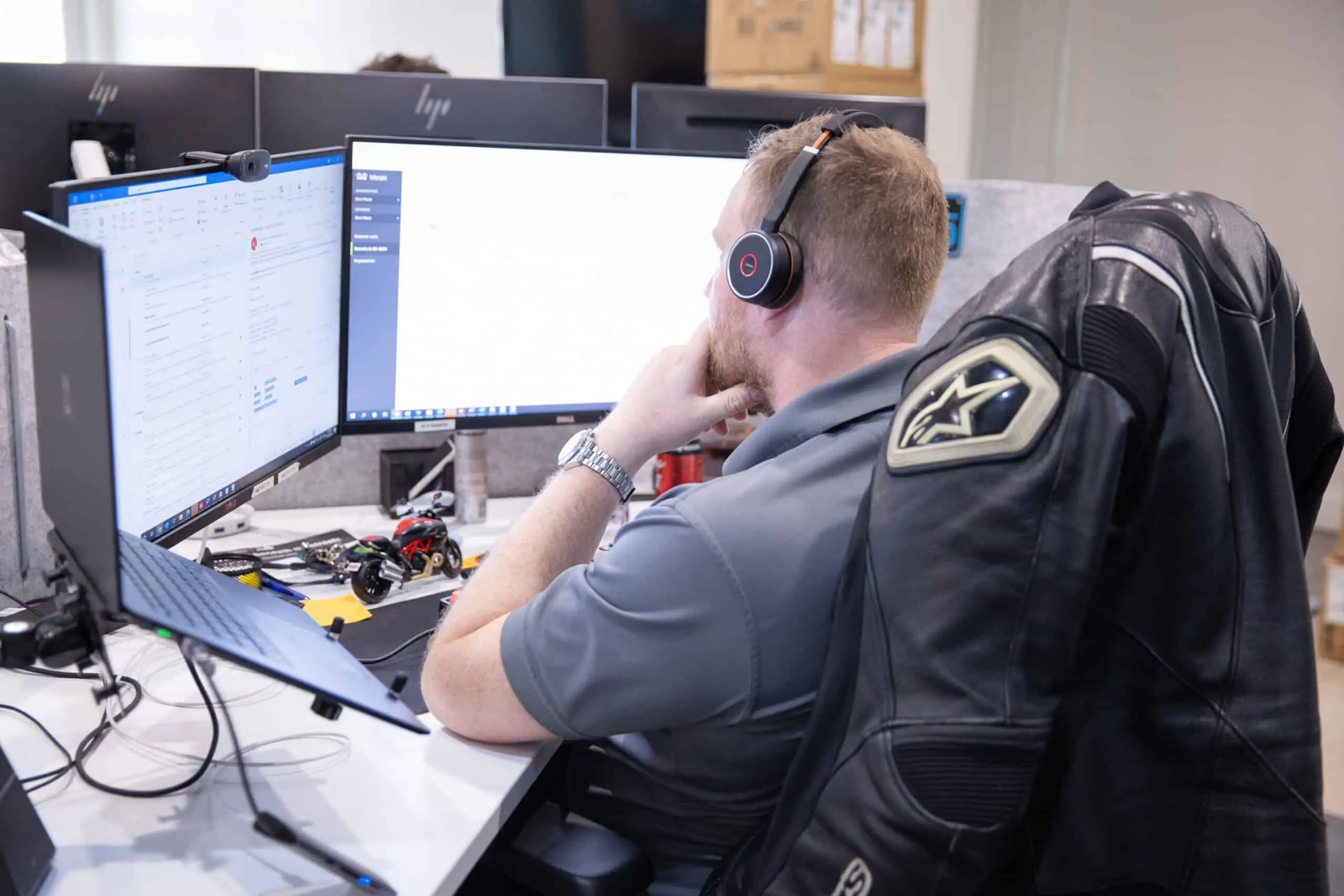 A member of the Envisage Technology team with multiple computer screens
