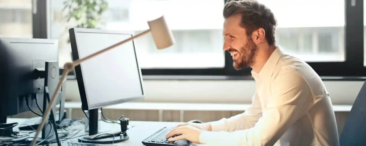 A happy business man working on a computer