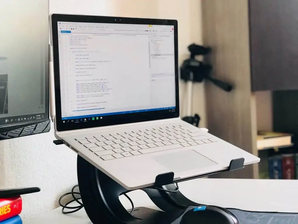 A laptop on a laptop stand in an office