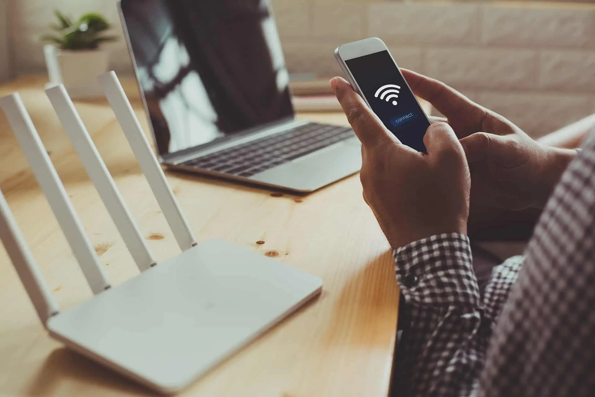 A businessman holding a phone trying to connect to the internet