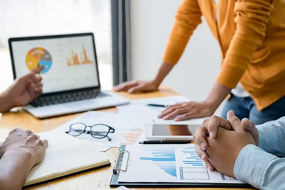 Employees in a meeting discussing business reports