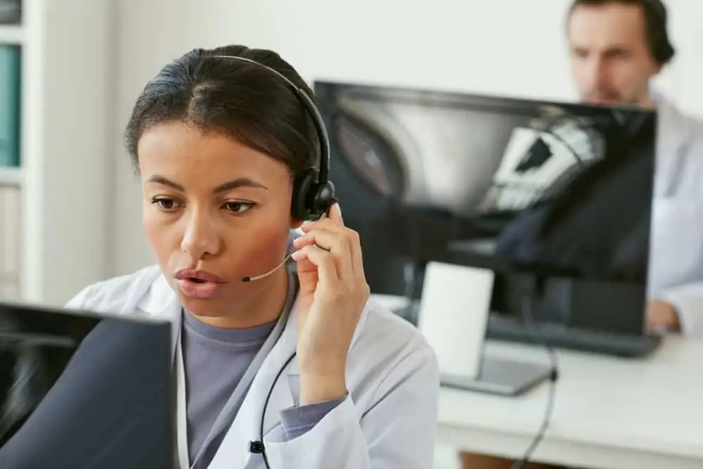 Young woman wearing a headset in a medical call centre environment