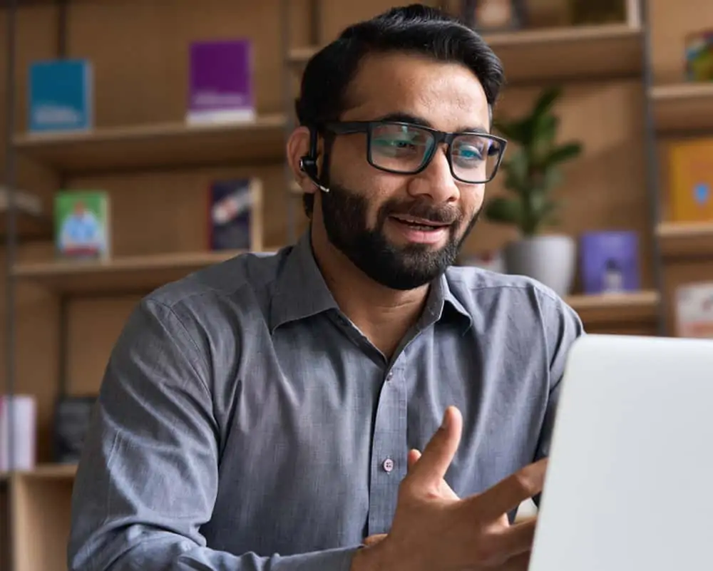 Indian business man speaking having virtual meeting on laptop.