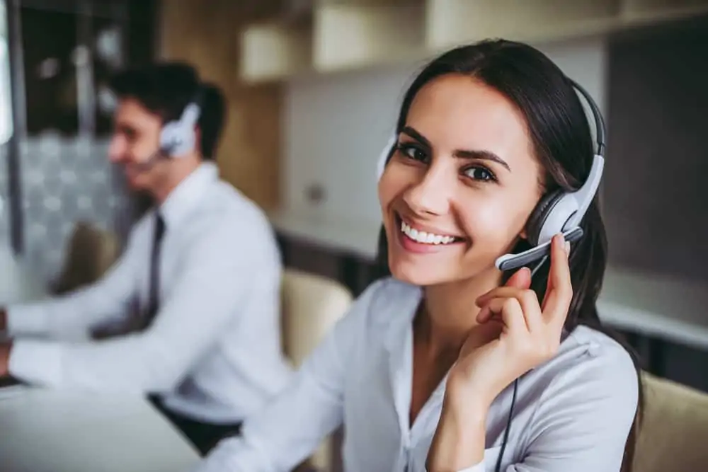 A happy smiling call centre worker wearing a headset
