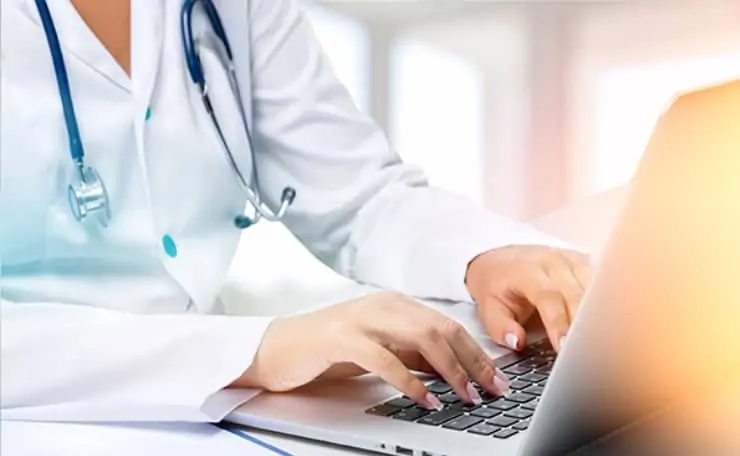 medical sector business with doctor typing on the laptop